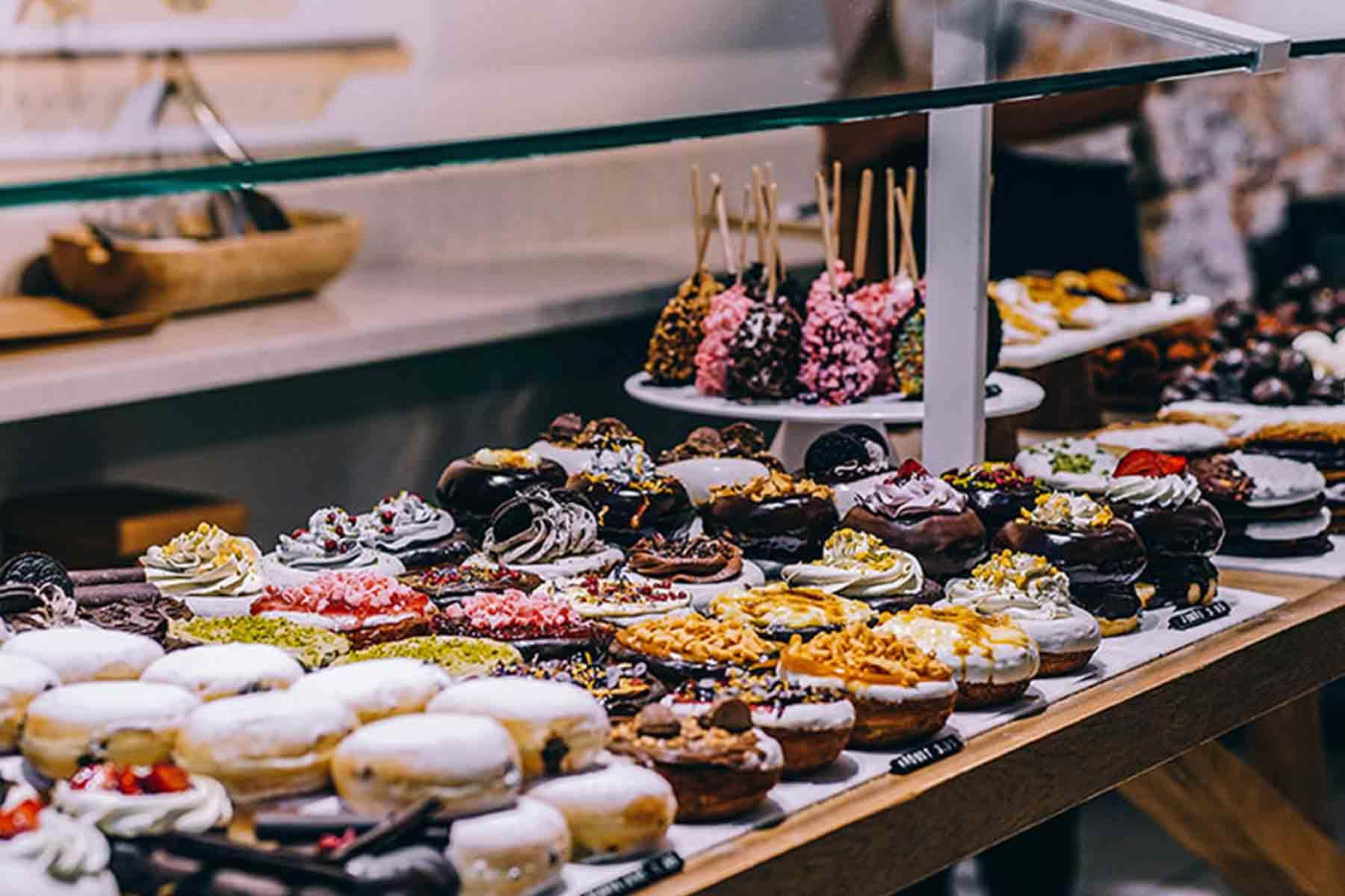 Rows of colorful deserts in glass case