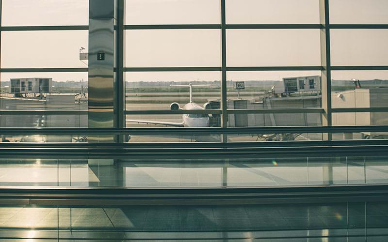 Looking out airport windows with parked plane outside