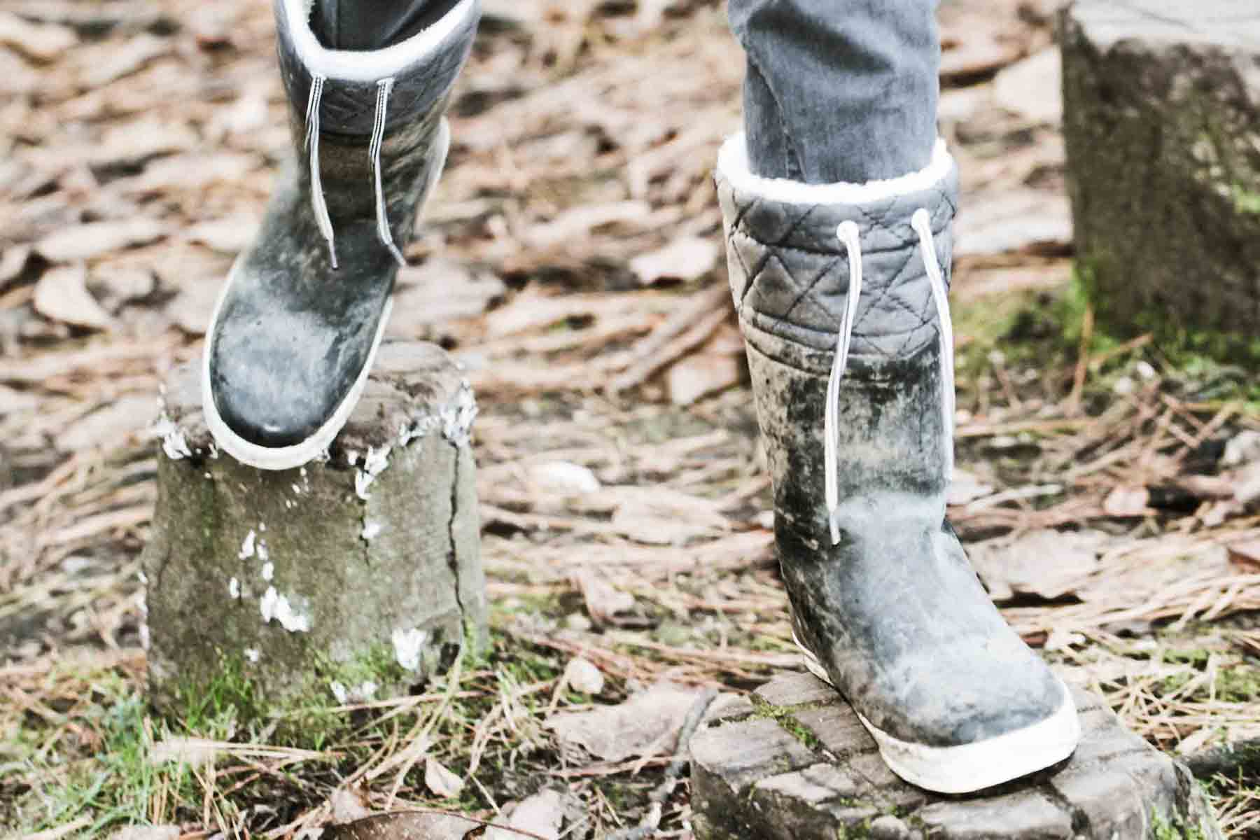 Person wearing boots while walking through woods