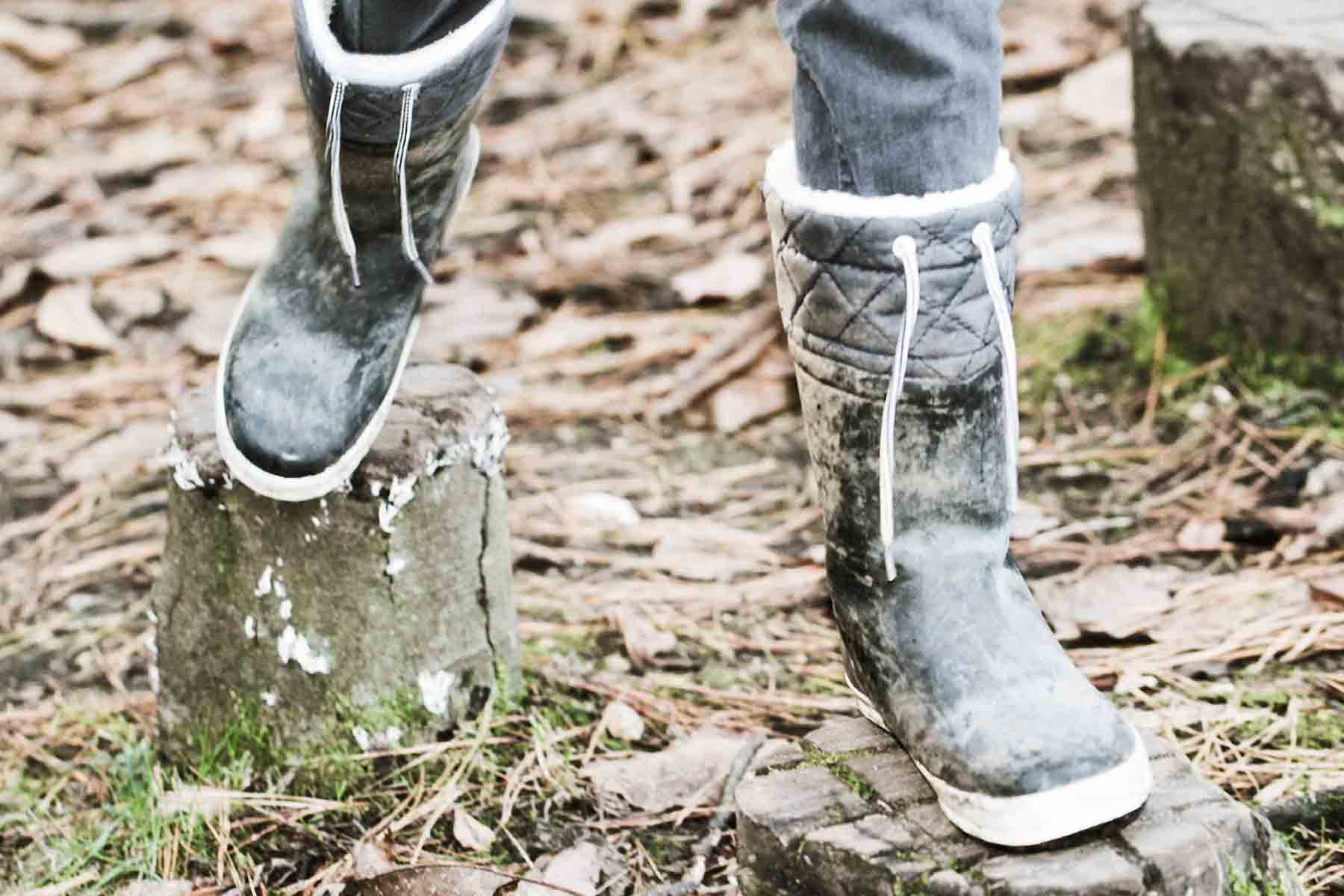 Person wearing boots while walking through woods