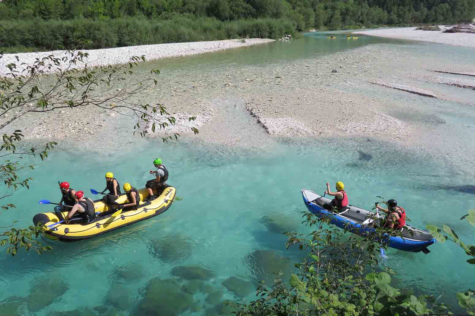 Teams of people in boats rowing their way down river