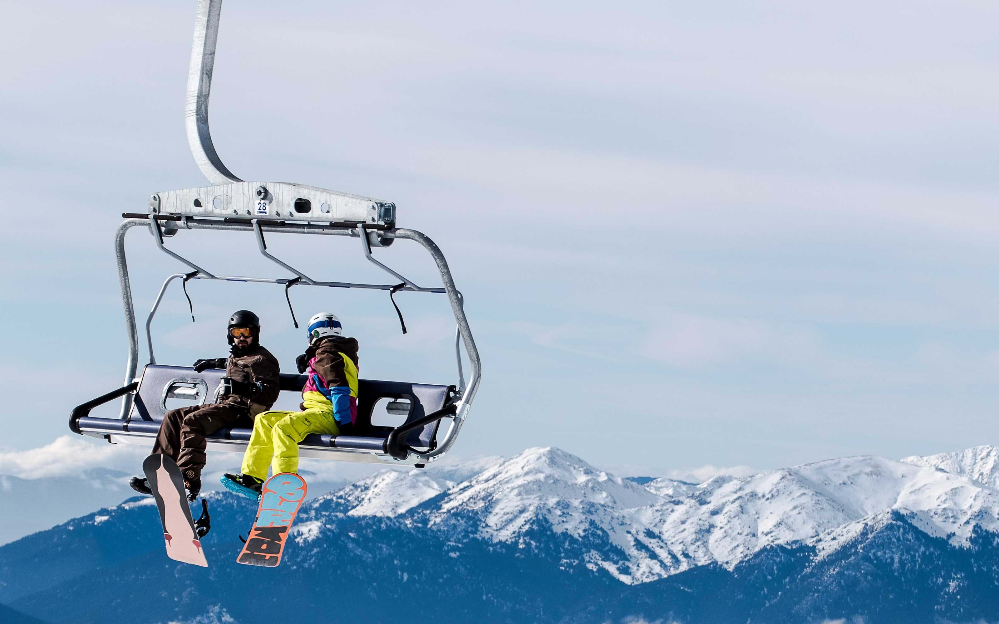 Pair of snowboarders on ski lift