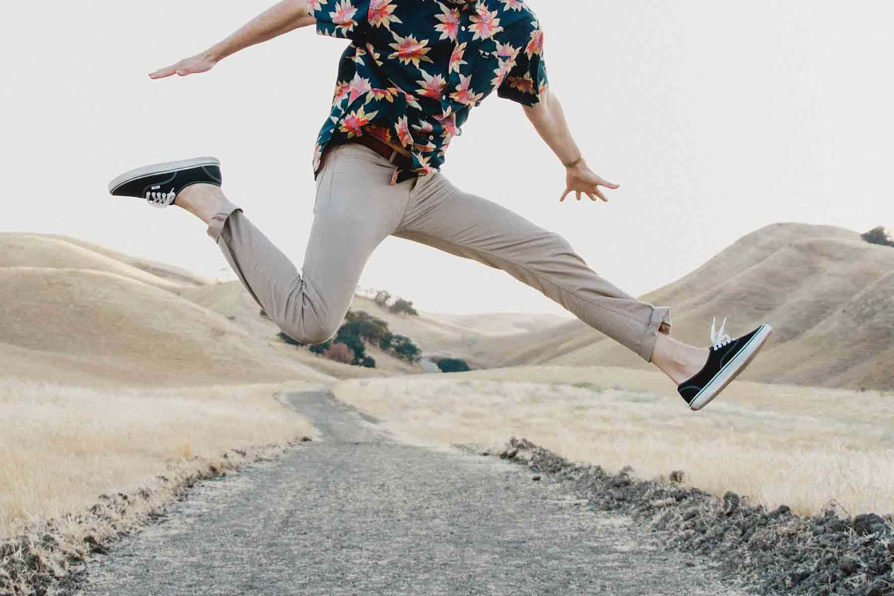 Person jumping over path