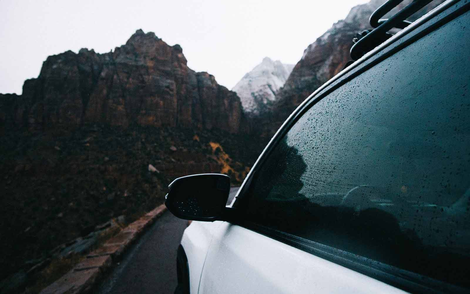 Car driving on road through mountains