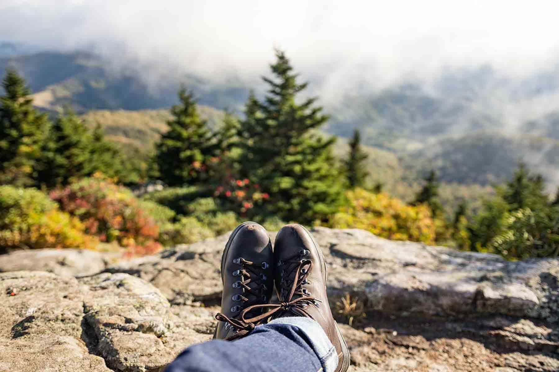 Crossed legs of person resting and enjoying view of landscape