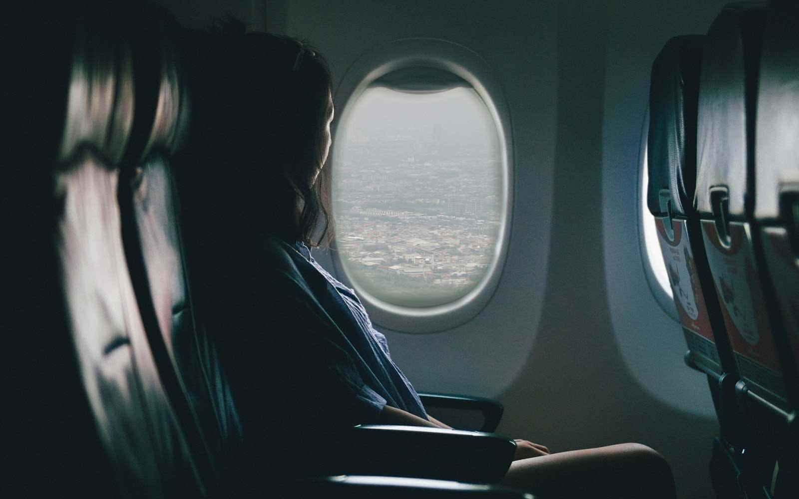 Passenger looking out plane window