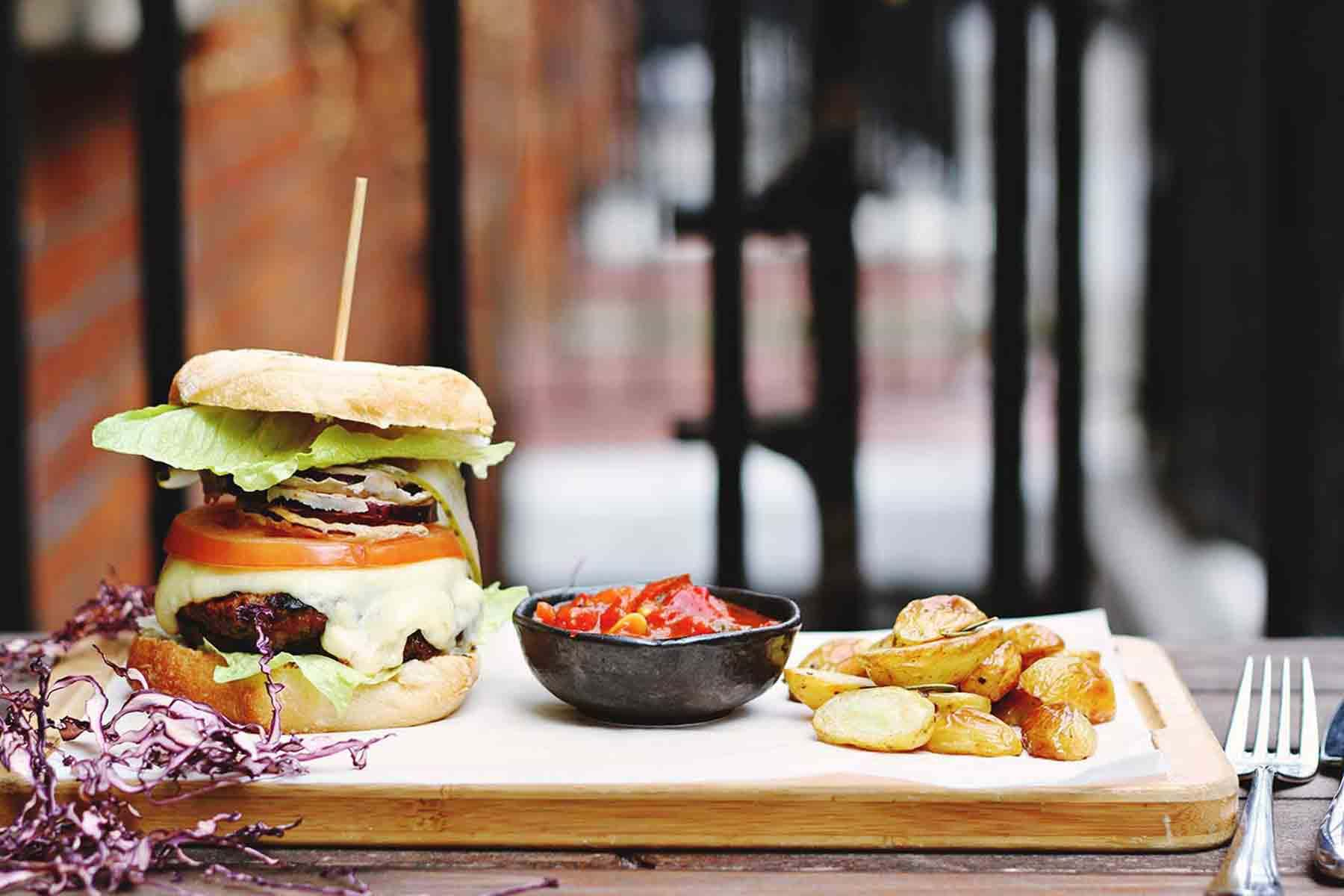 Gourmet burger and potatoes served on board