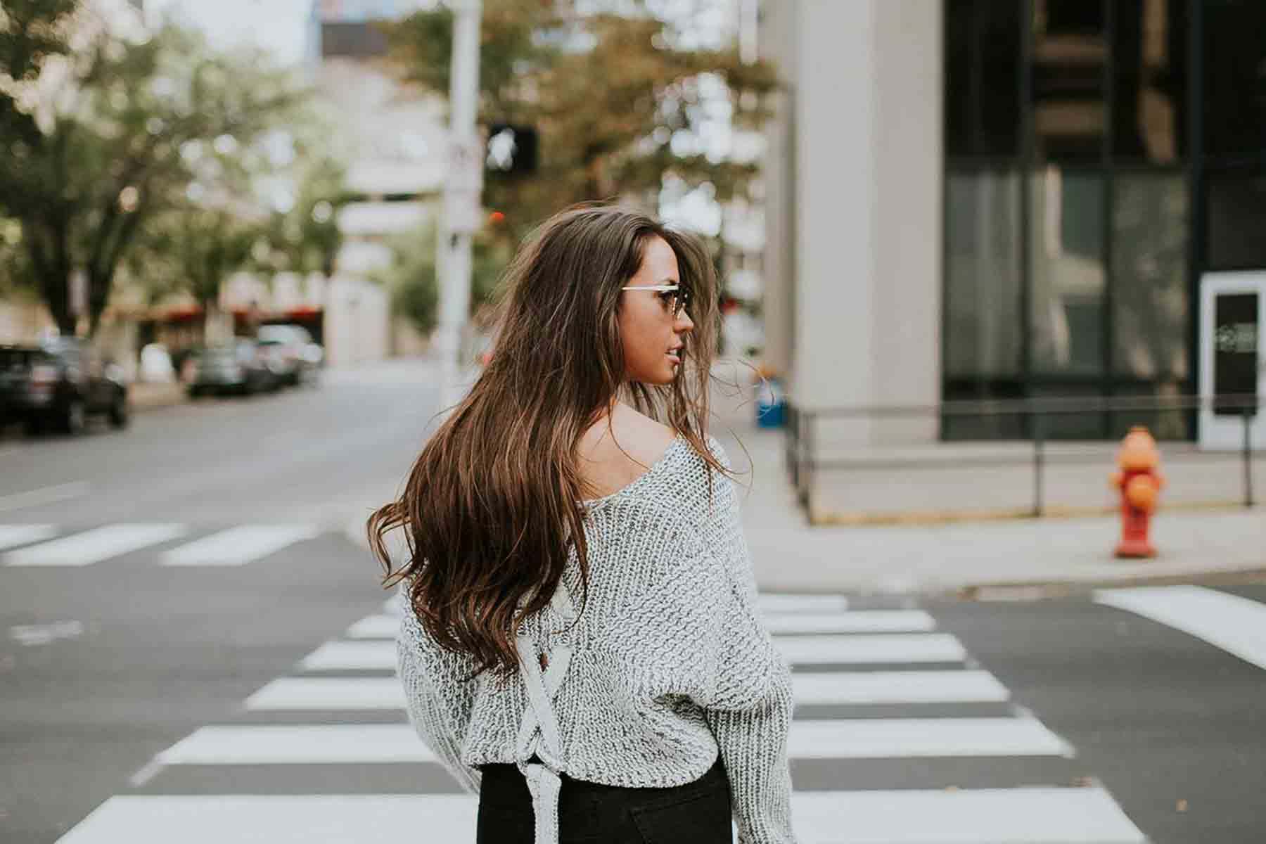 Woman using crosswalk in city