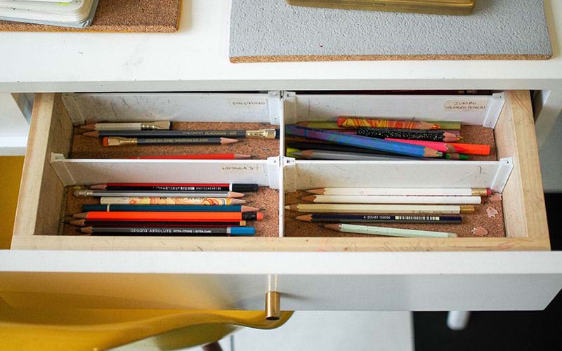 Drawer filled with pencils and art brushes