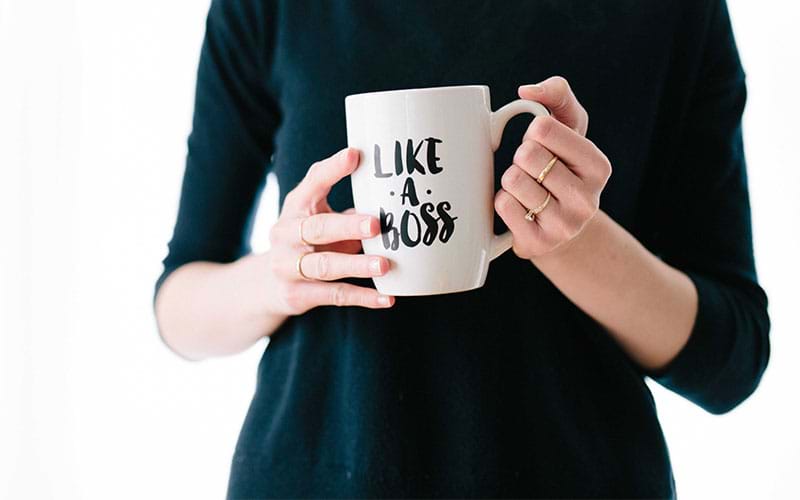 Woman holding mug that reads "like a boss"