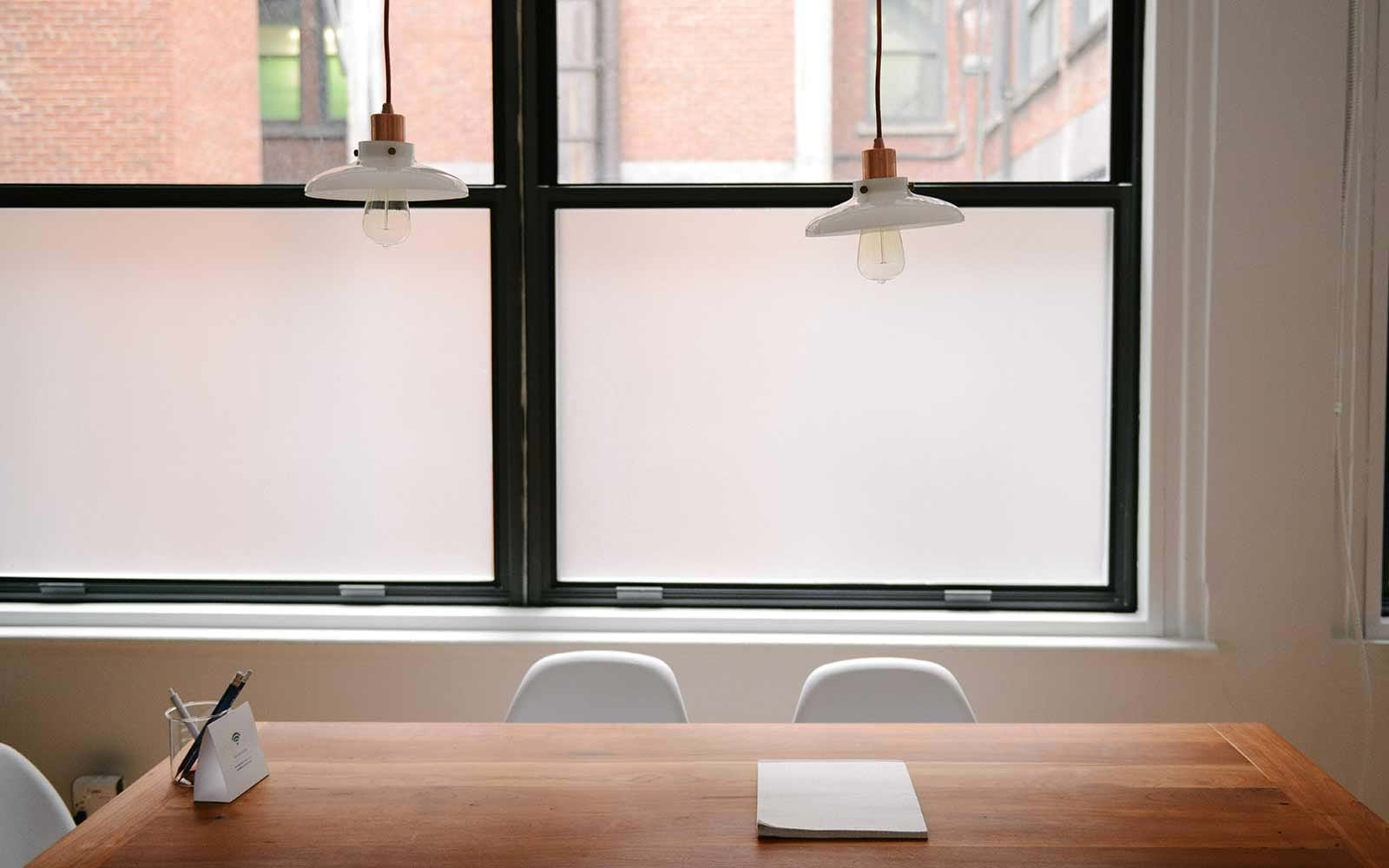 Meeting table with two small lights hanging above