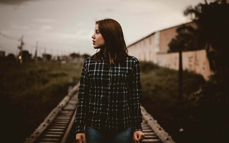 Woman walking on traintracks