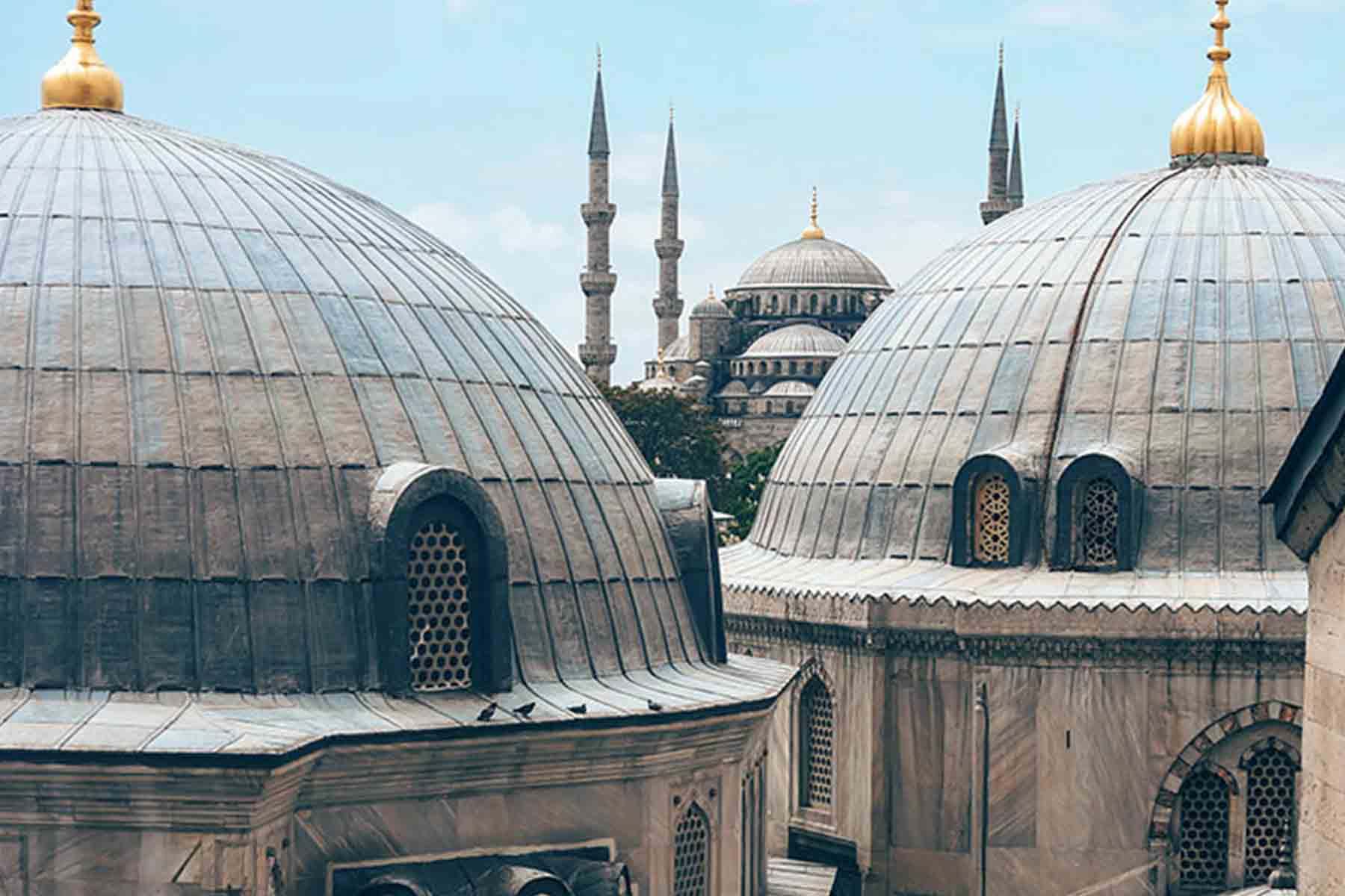 Domed buildings in Istanbul with Blue Mosque behind
