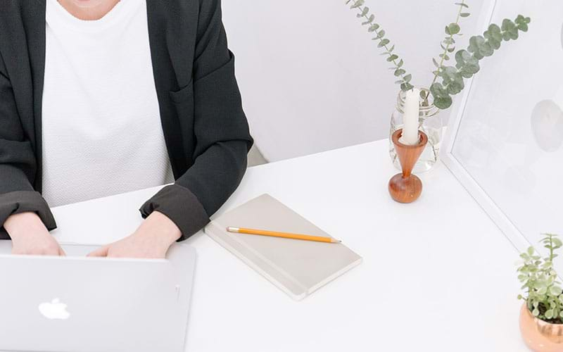 Person working on laptop in white office