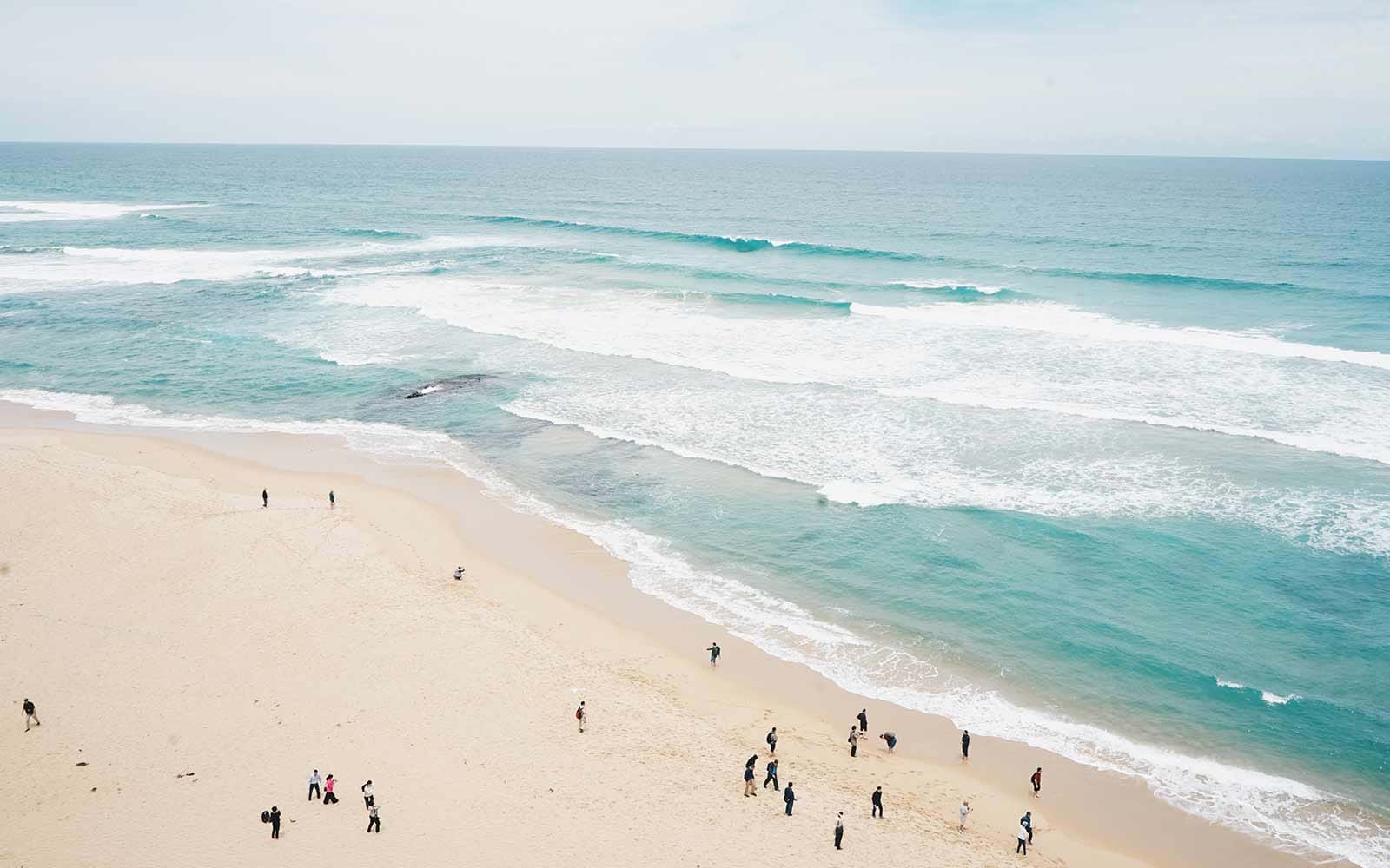 Sparse groups of people on large beach