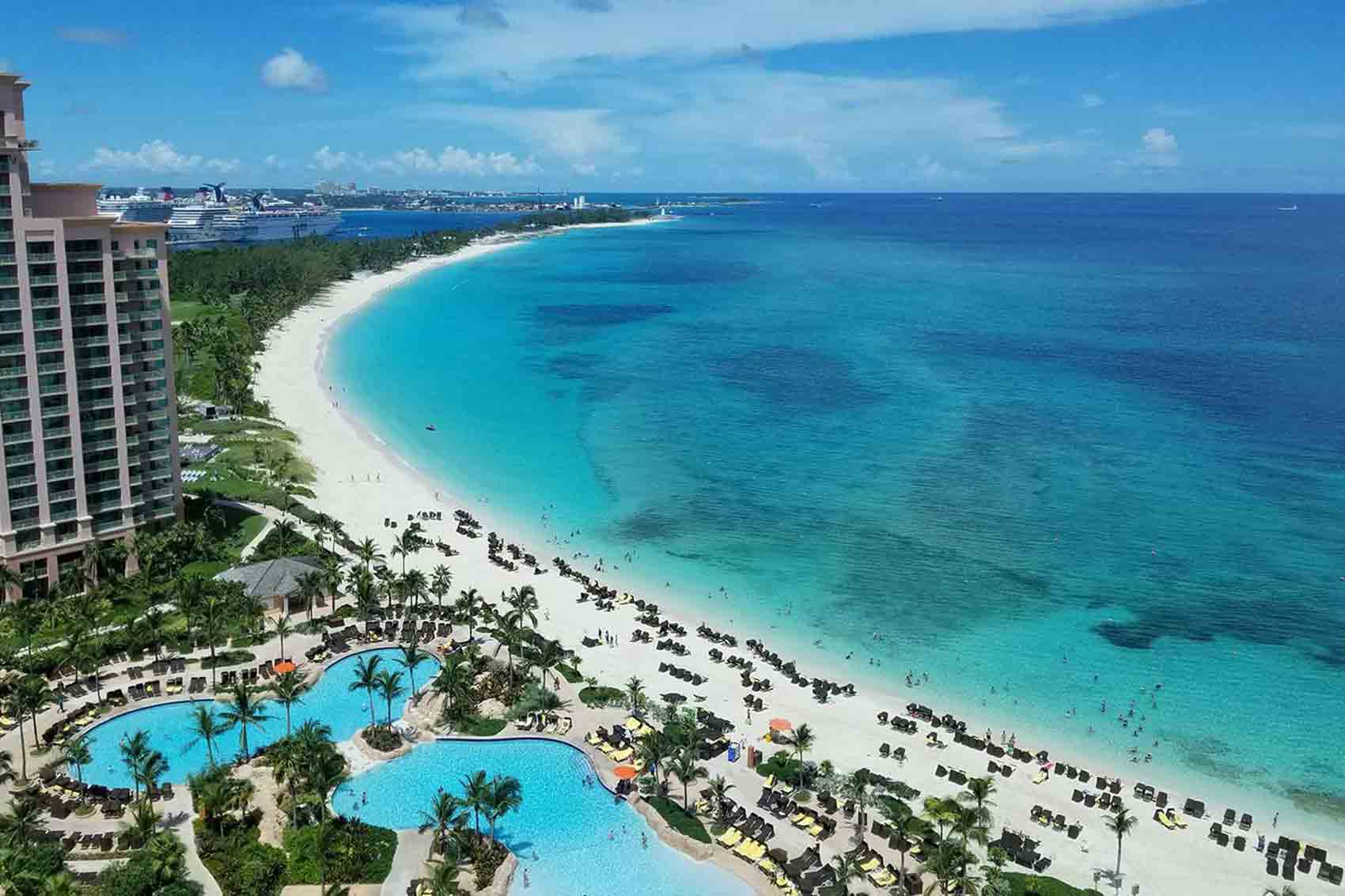 Long curved beach with clear blue waters