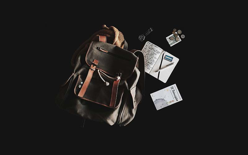 Backpack lying next to passport and other essentials