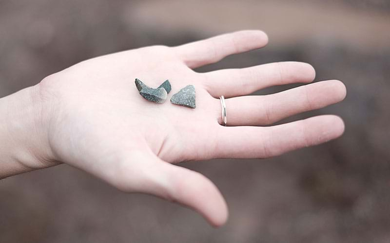 Hand holding small stones