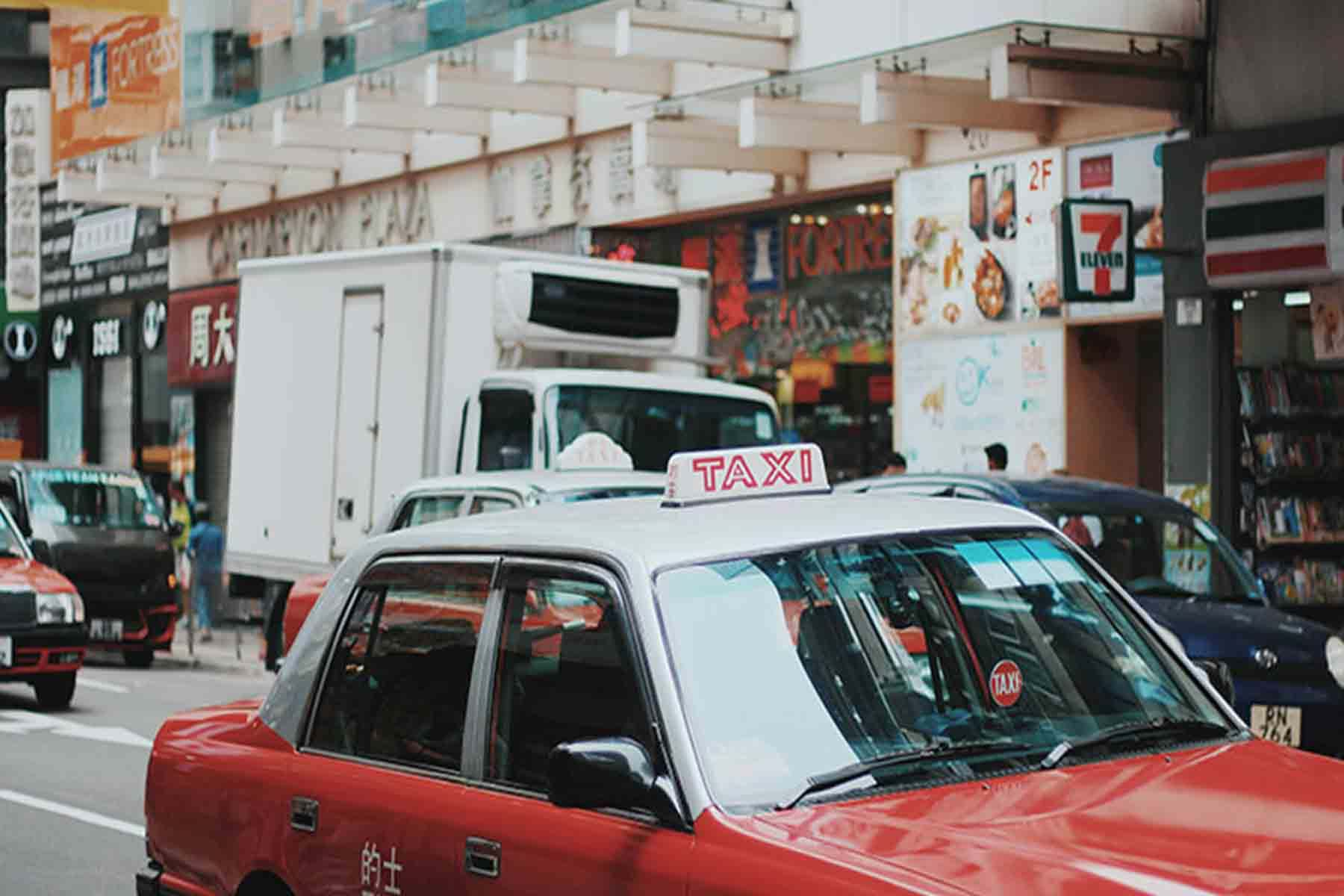 Taxi driving in middle of busy city street