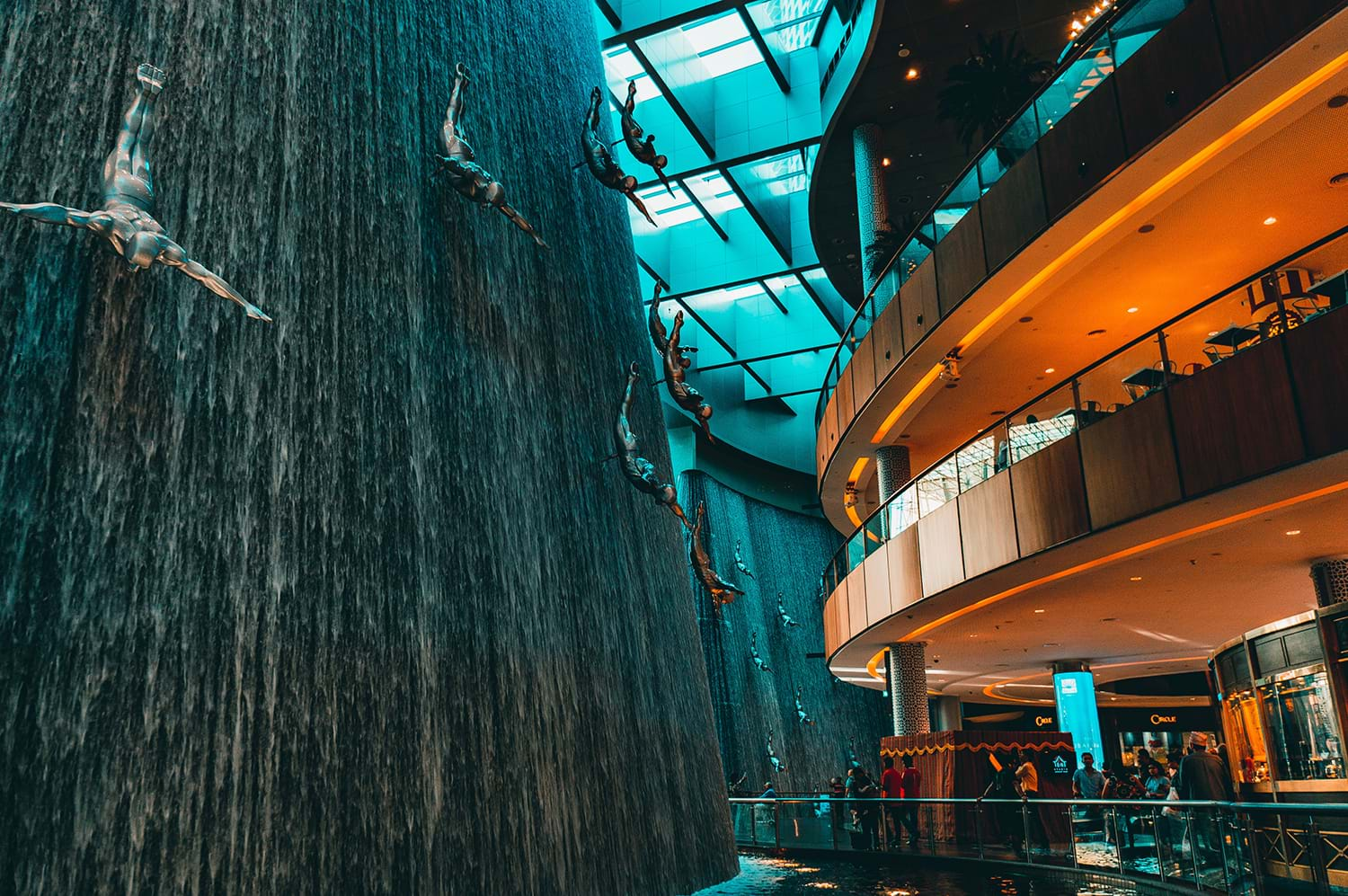 Interior artificial waterfall with sculptures of people diving