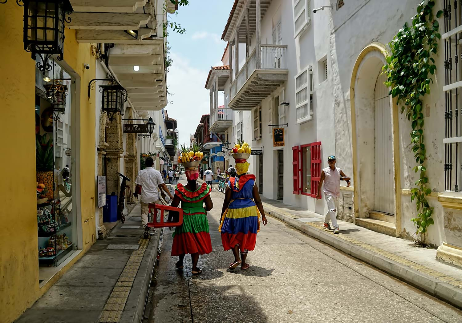 Two women walking down city street