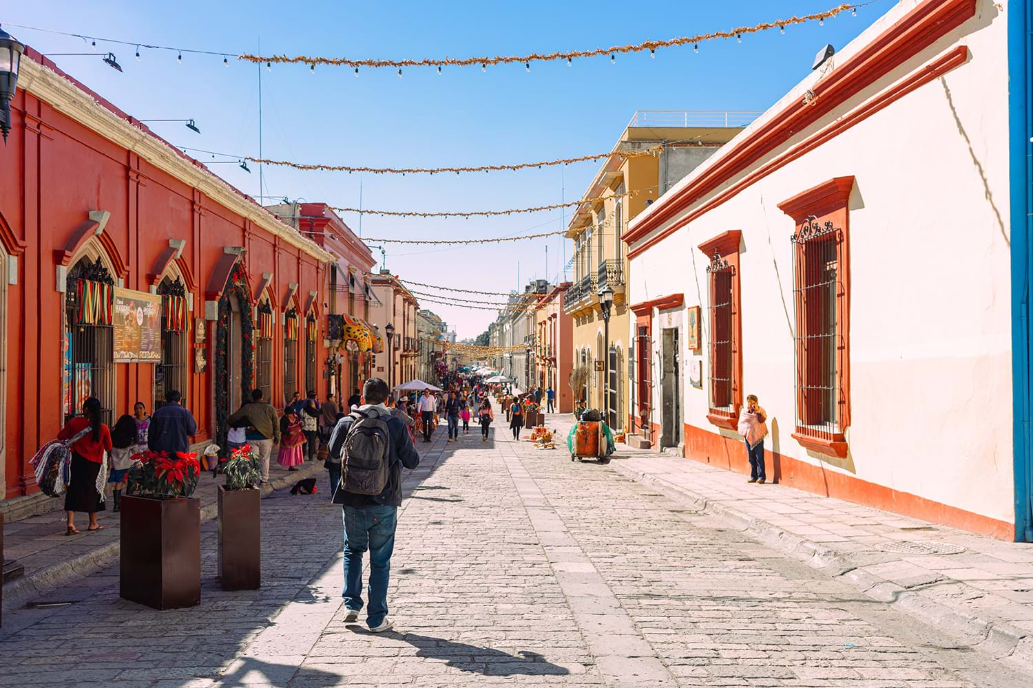 People walking down colorful street