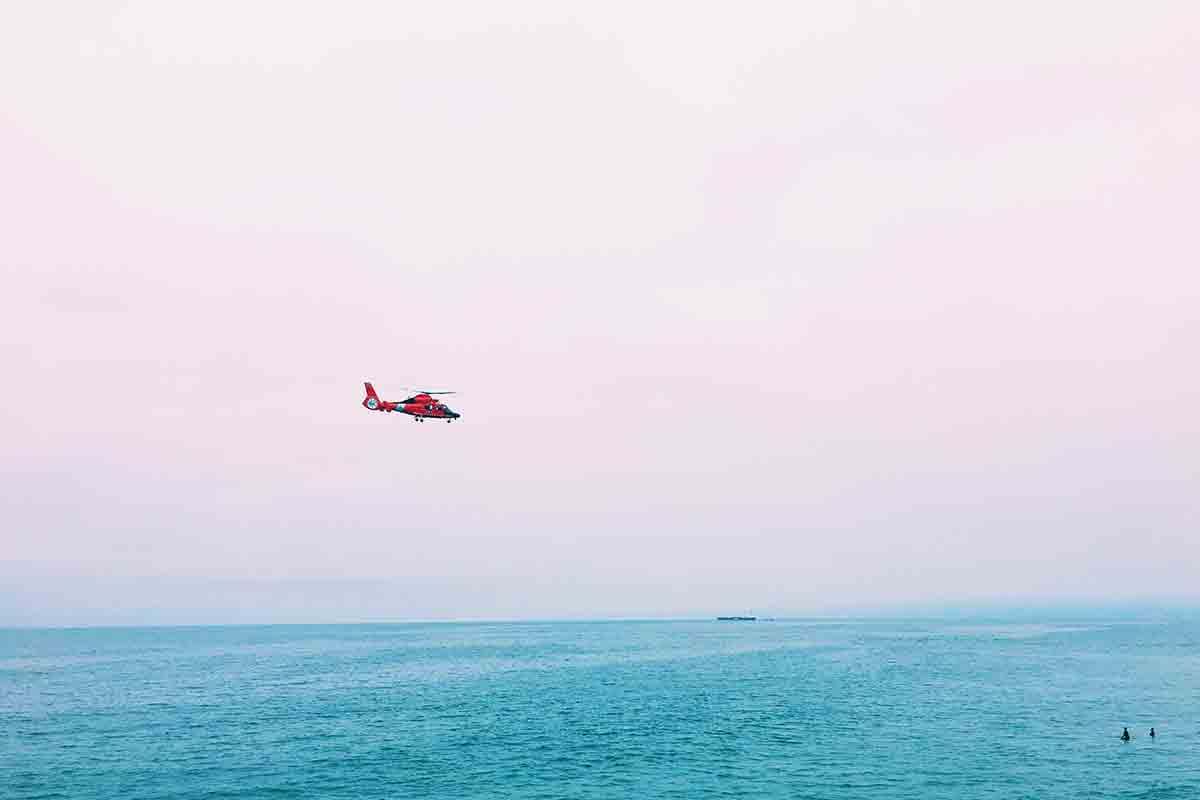 Rescue helicopter flying over the ocean
