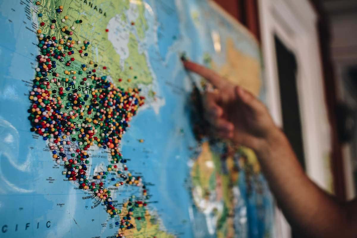 Map of world covered in pins showing locations visited