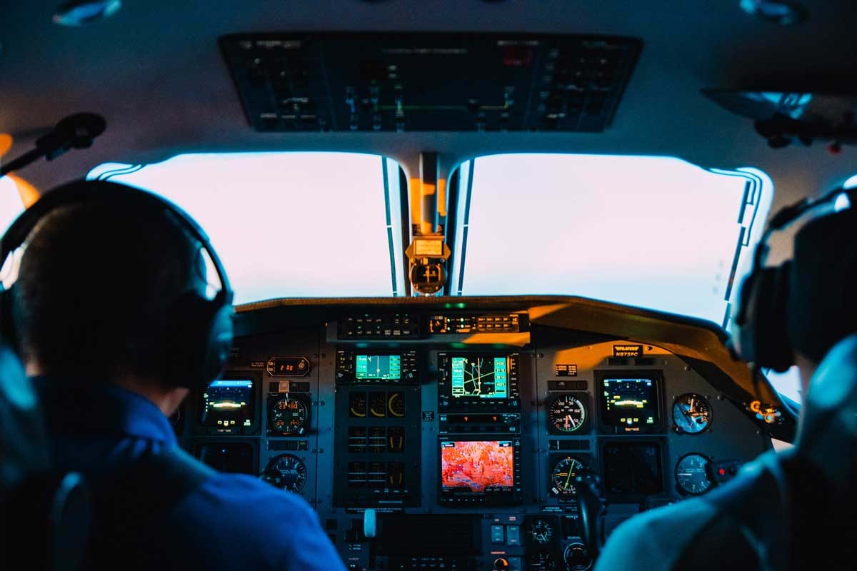 Two pilots sitting in plane cockpit