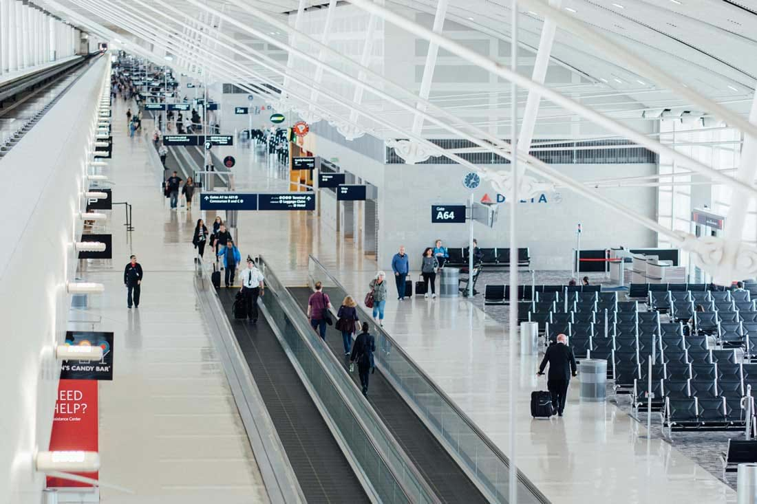 People walking through airport terminal