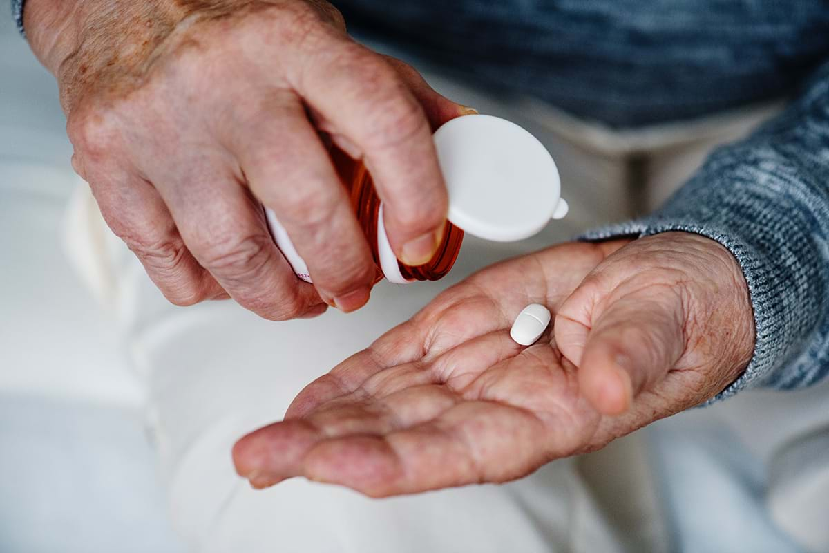 Elderly person taking medication