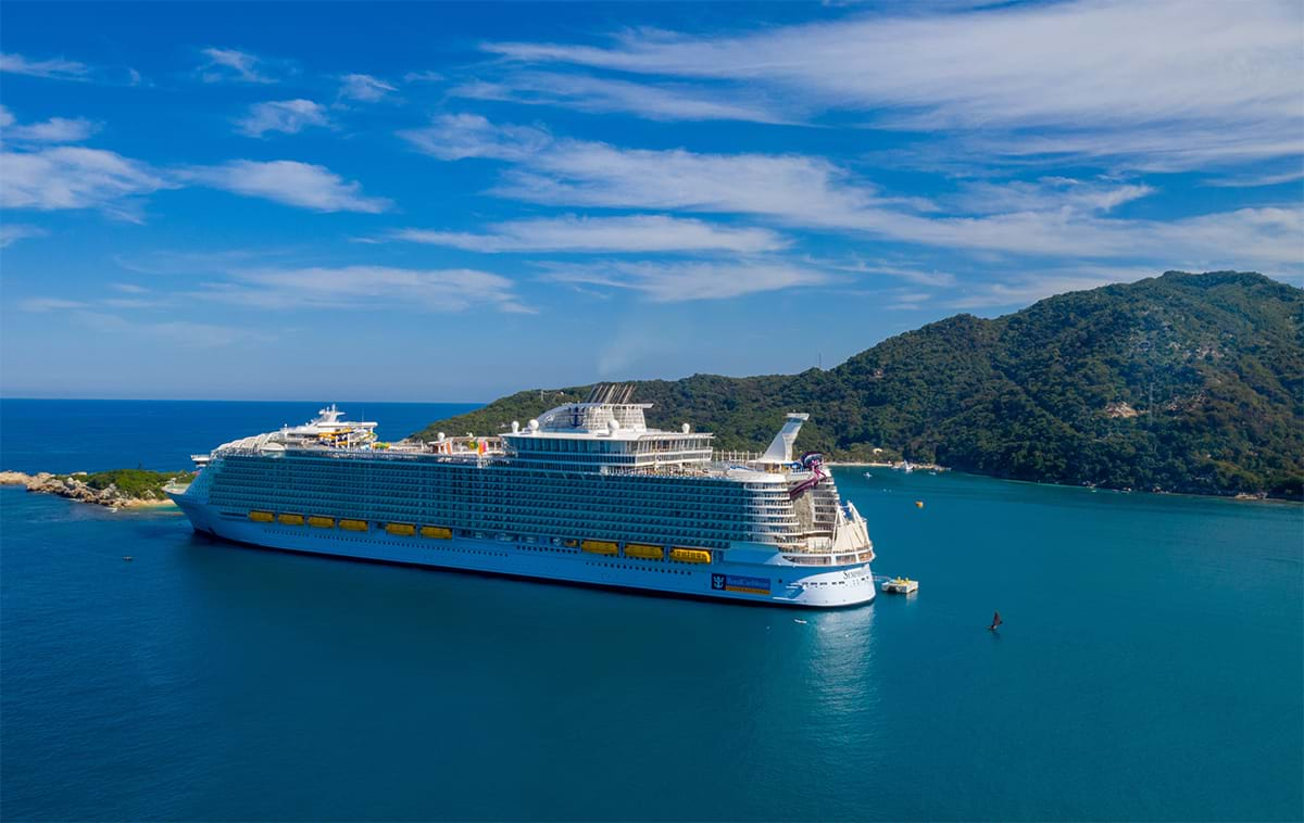 Large cruise ship docked at island