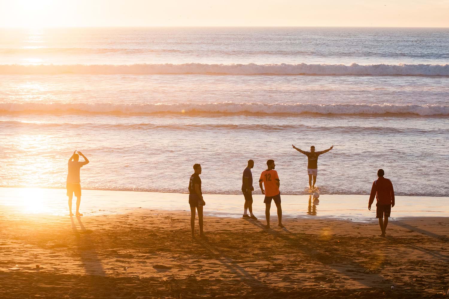 Group of friends on beach at sunset