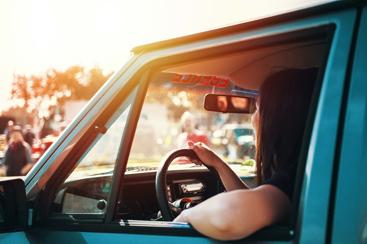 Woman driving truck in glaring sun