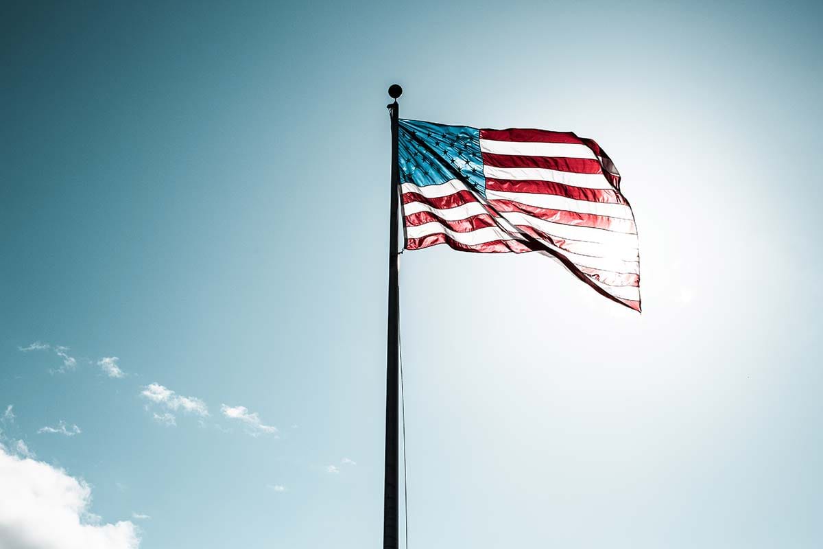 Sun shining through American flag