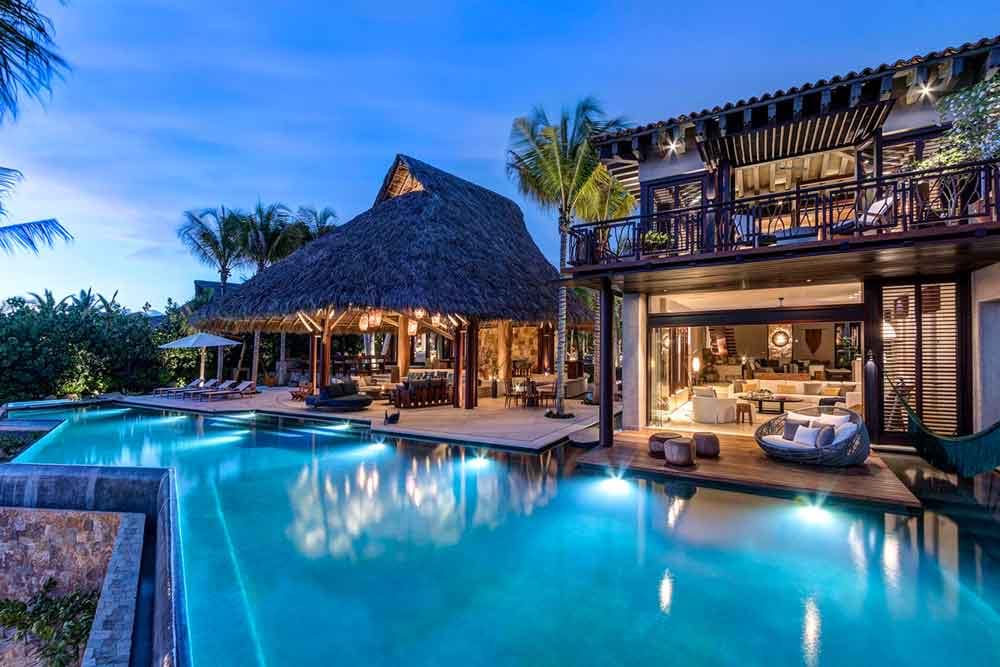 Luxury villa with lit patio and large pool