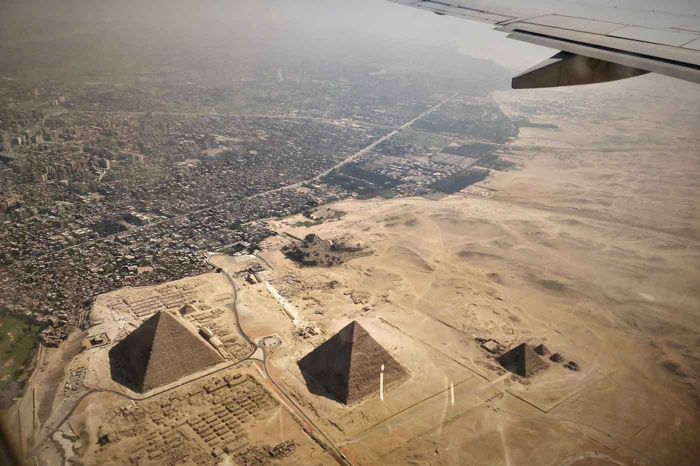 View from plane flying over pyramids and city