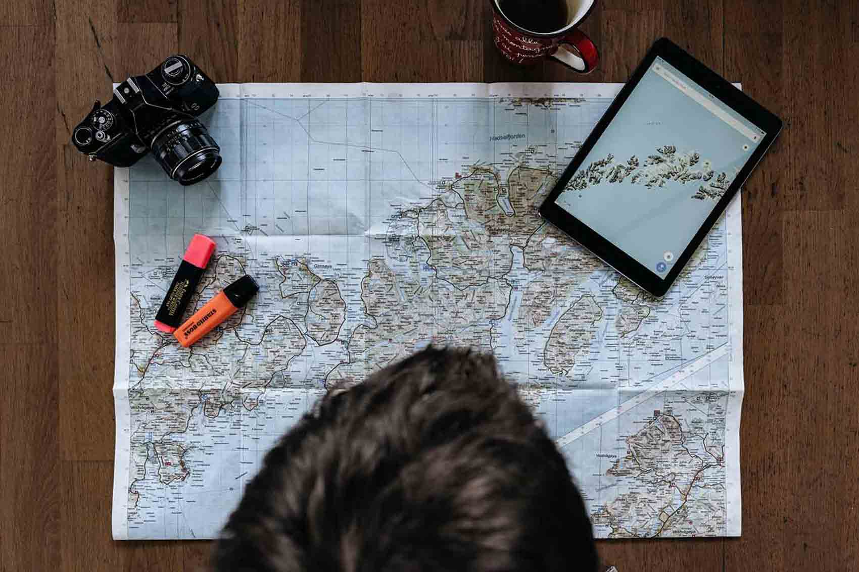 Person studying map on table 