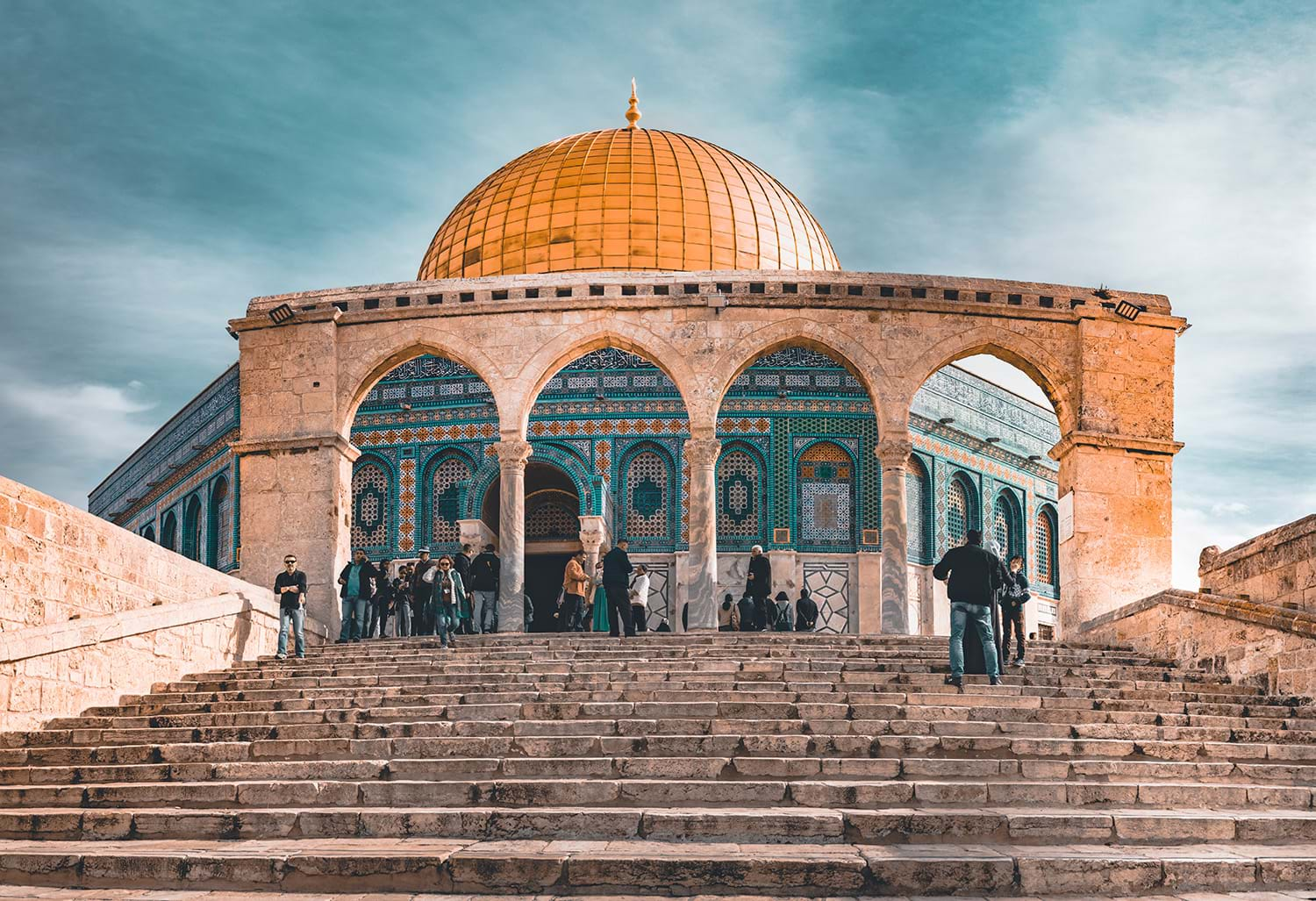 Steps leading up to gold domed mosque