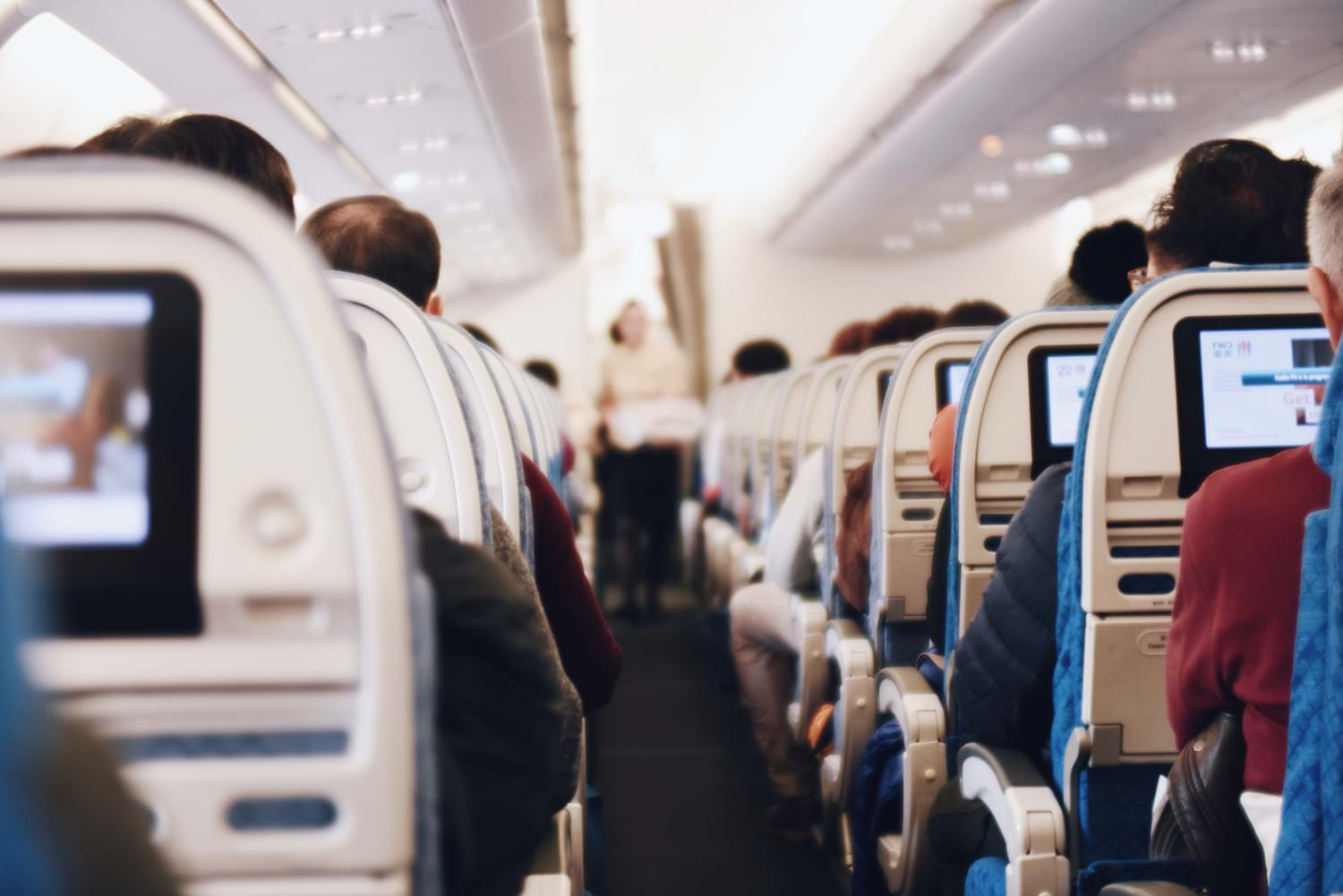 Airplane passengers watching screens 