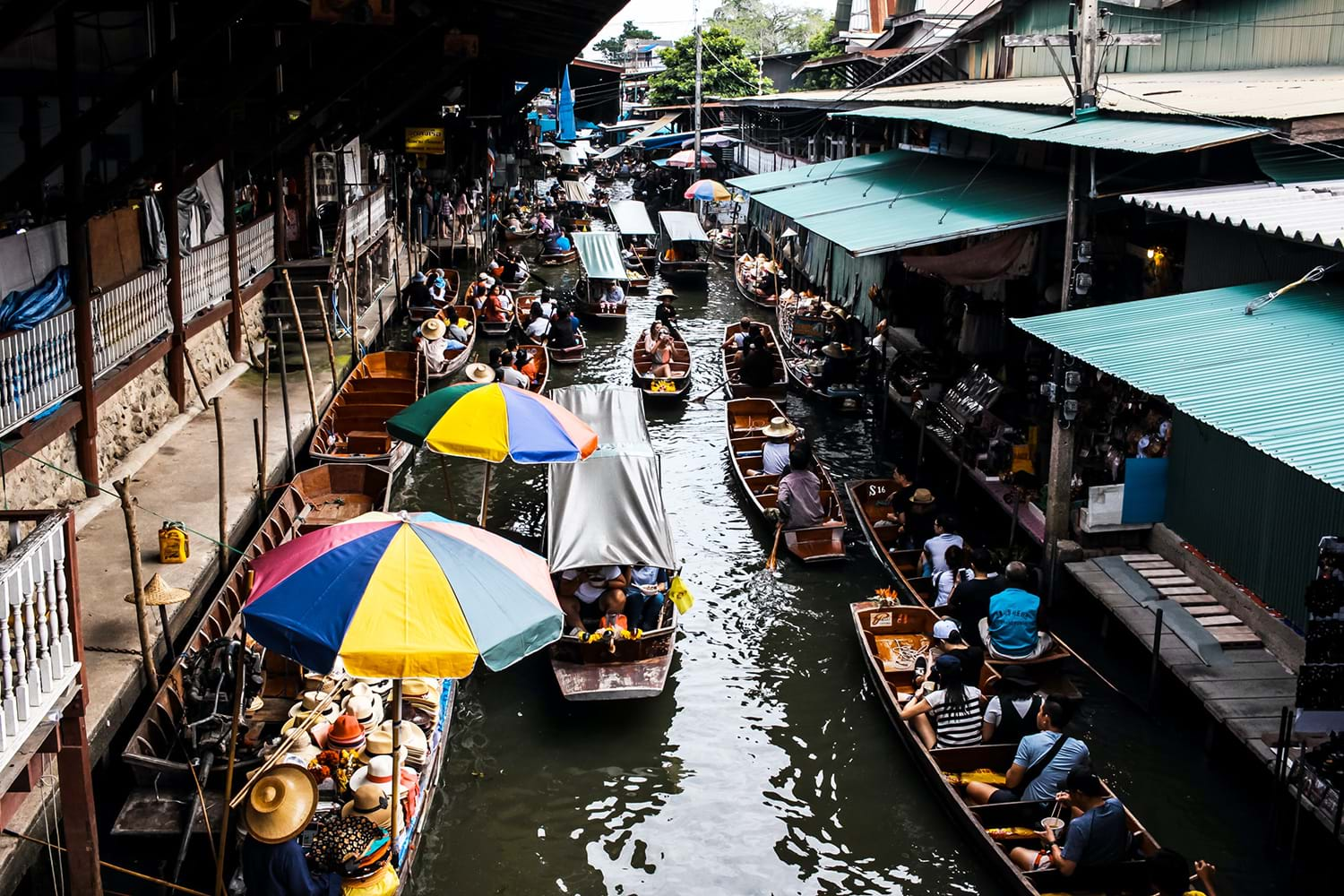 Small rowboats going down city canal