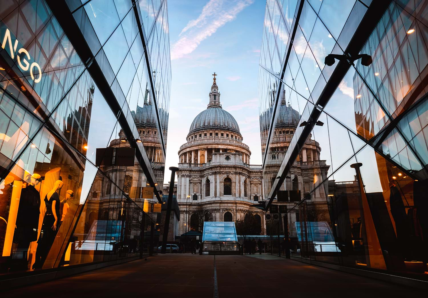 Path to domed building flanked by glass walls