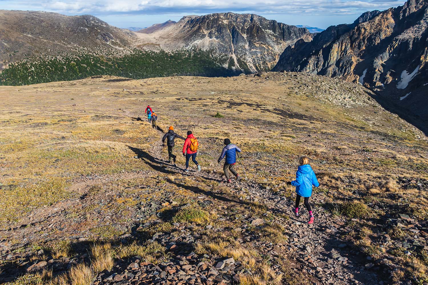 Group following hiking trail through rocky landscape