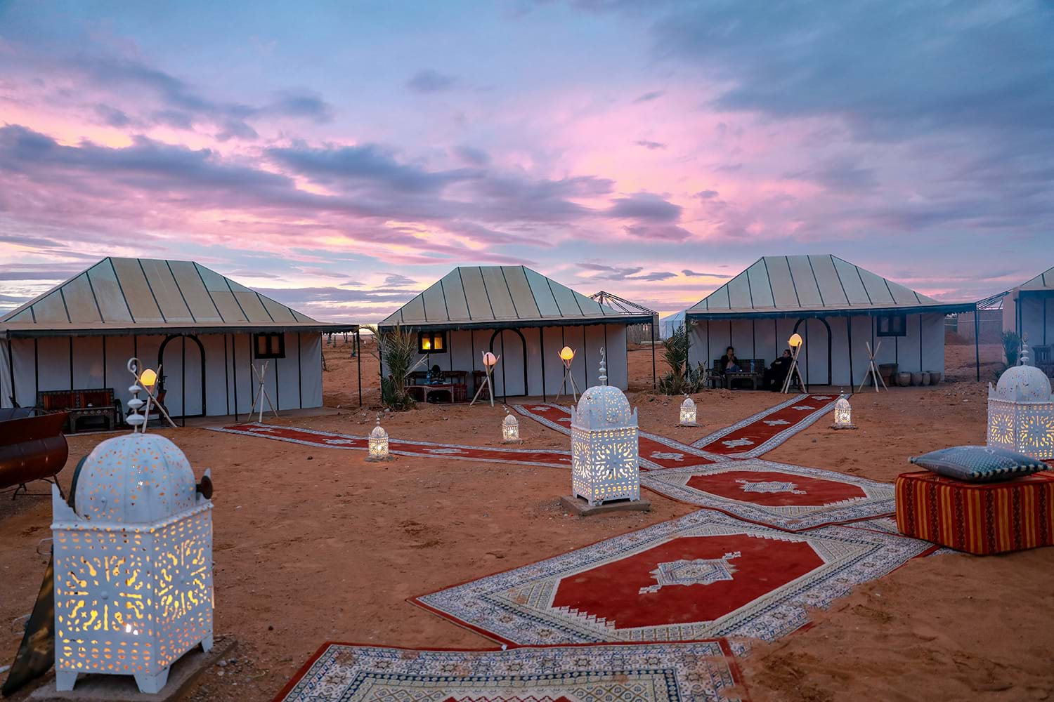 Tent houses connected by rugs in desert