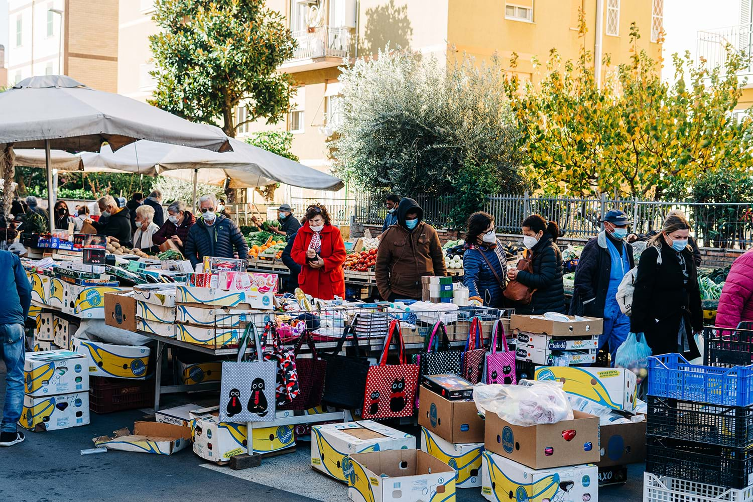 People in masks perusing farmers market