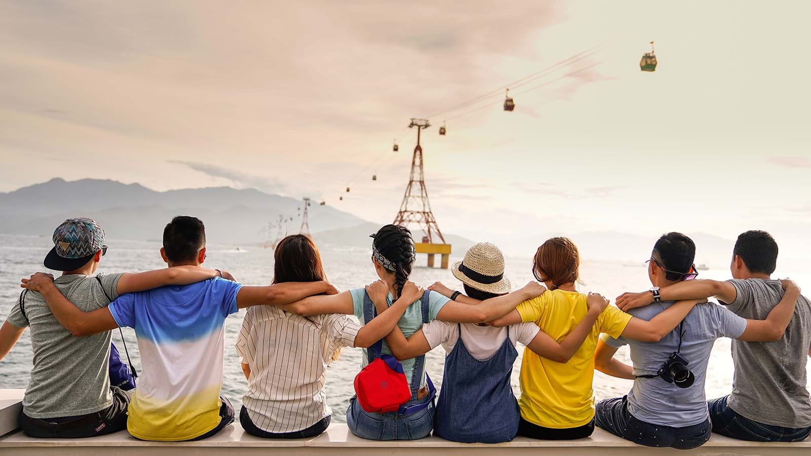 Line of young friends with arms over each other's shoulders