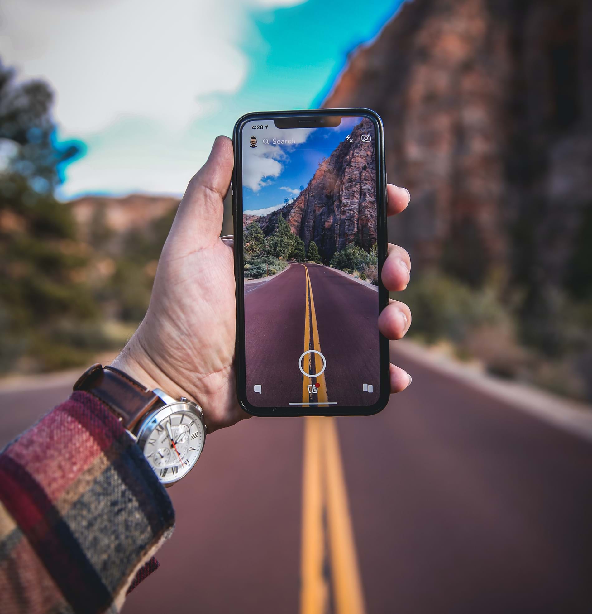 Holding phone with camera open at road ahead