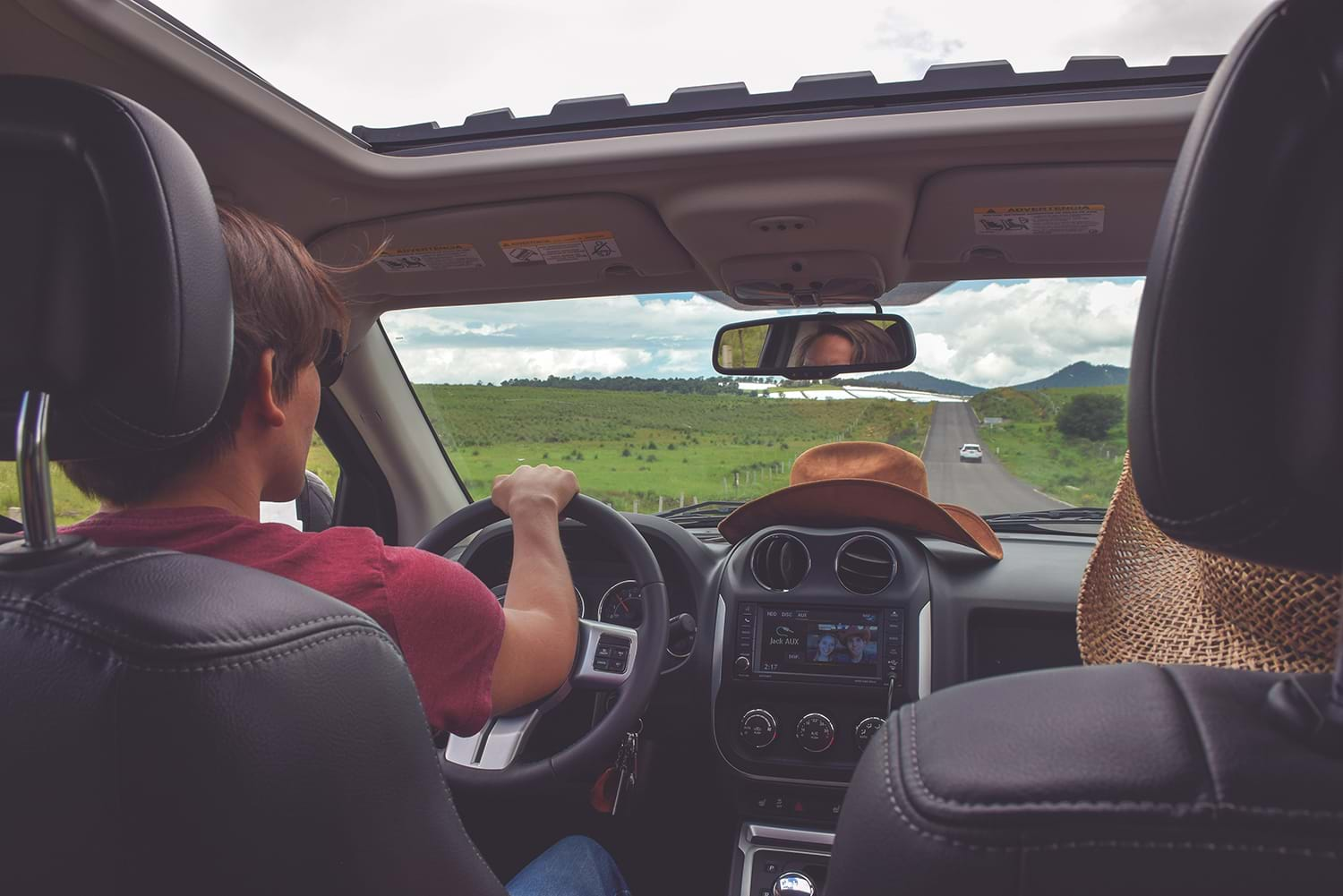 Couple in car driving down country road