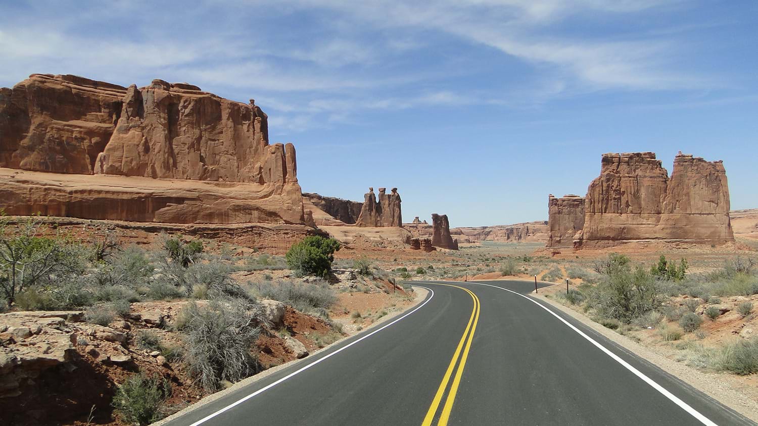 Desert highway passing through rock formations