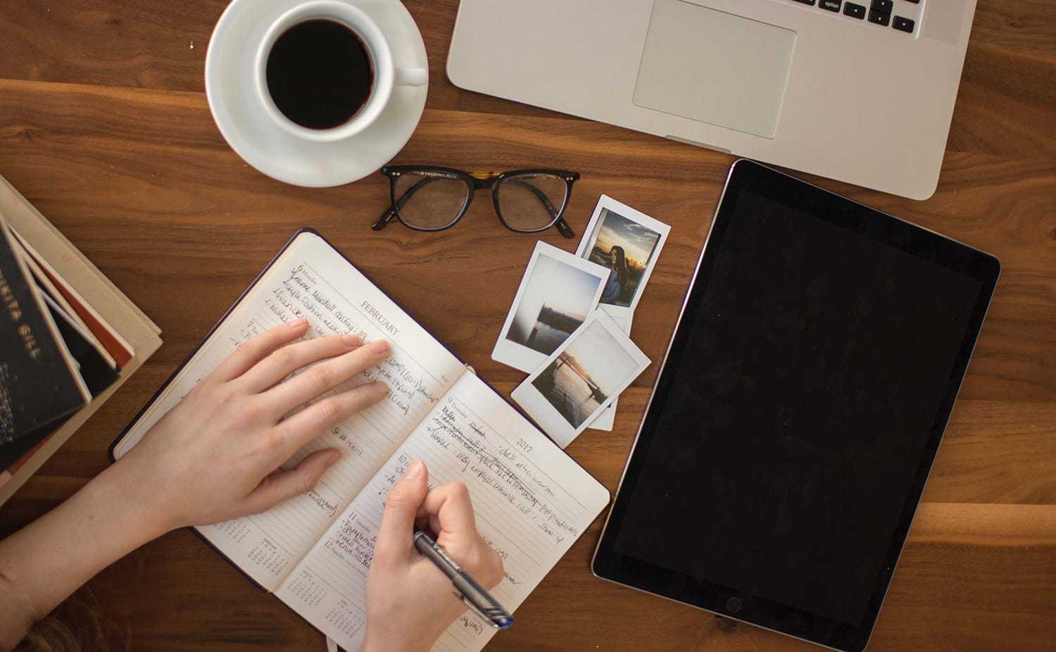 Person writing in notebook while doing research